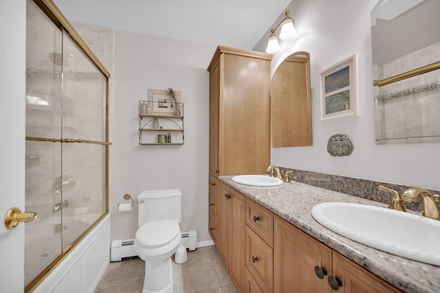 37 Scenic Cir, Croton-On-Hudson, NY 10520 - bathroom featuring a baseboard heating unit, bath / shower combo with glass door, tile patterned flooring, and double vanity