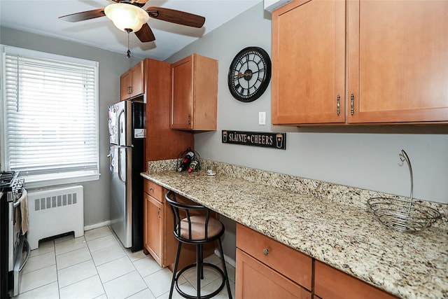 200 N Village Ave Unit D5, Rockville Centre, NY 11570 - kitchen with radiator, freestanding refrigerator, plenty of natural light, and a ceiling fan