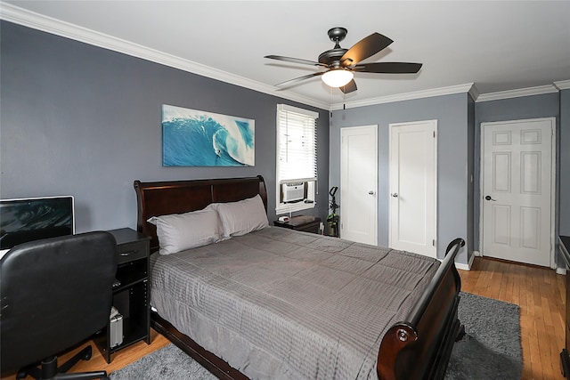 200 N Village Ave Unit D5, Rockville Centre, NY 11570 - bedroom with light wood-style flooring, crown molding, two closets, a ceiling fan, and a desk