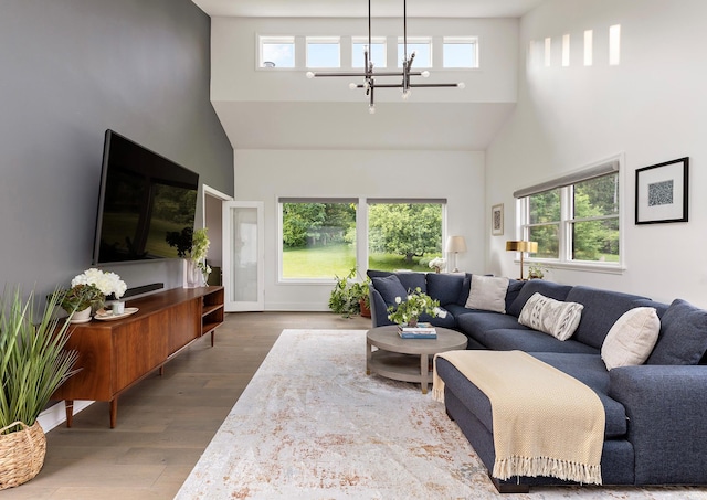 62 Hicks Ln, Clinton Corners, NY 12514 - living room with a towering ceiling, a chandelier, and dark wood-type flooring