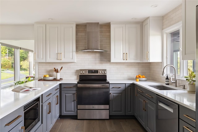 62 Hicks Ln, Clinton Corners, NY 12514 - kitchen featuring appliances with stainless steel finishes, wall chimney exhaust hood, a sink, gray cabinetry, and white cabinetry