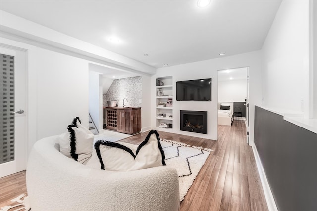 21 Hillside Dr W, Sag Harbor, NY 11963 - living room featuring light wood-type flooring, baseboards, recessed lighting, a fireplace, and built in shelves
