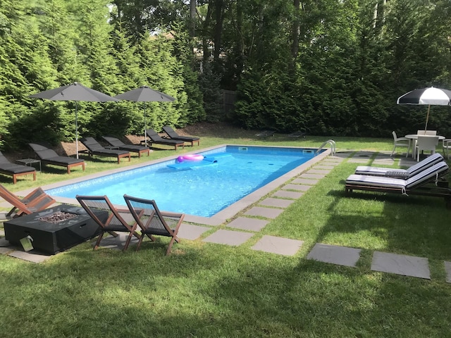 21 Hillside Dr W, Sag Harbor, NY 11963 - outdoor pool featuring an outdoor fire pit, a yard, and a view of trees
