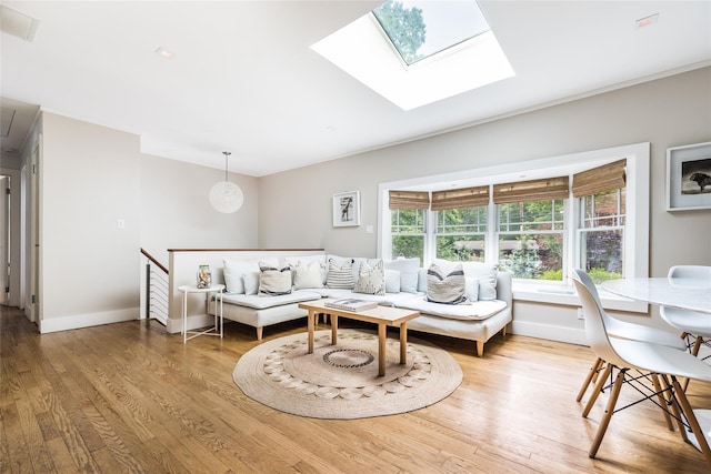 21 Hillside Dr W, Sag Harbor, NY 11963 - living area with wood finished floors, baseboards, and a skylight