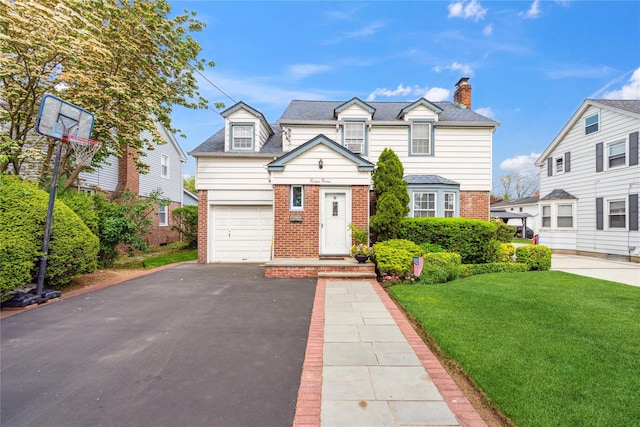 1515 Kenneth Ave, Baldwin, NY 11510 - view of front of property with brick siding, asphalt driveway, a front lawn, and a garage