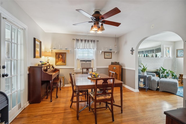 1515 Kenneth Ave, Baldwin, NY 11510 - dining room featuring arched walkways, a ceiling fan, cooling unit, wood finished floors, and baseboards
