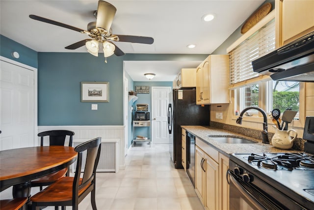 1515 Kenneth Ave, Baldwin, NY 11510 - kitchen with black gas stove, a sink, ceiling fan, a wainscoted wall, and dishwasher