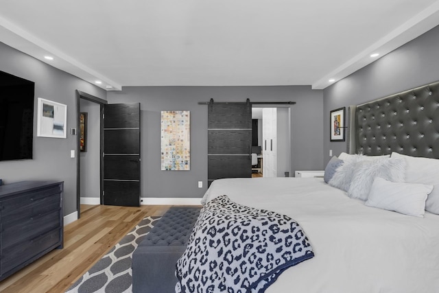 345 E 93rd St Unit 25Ak, New York Manhattan, NY 10128 - bedroom featuring recessed lighting, wood finished floors, a barn door, and baseboards