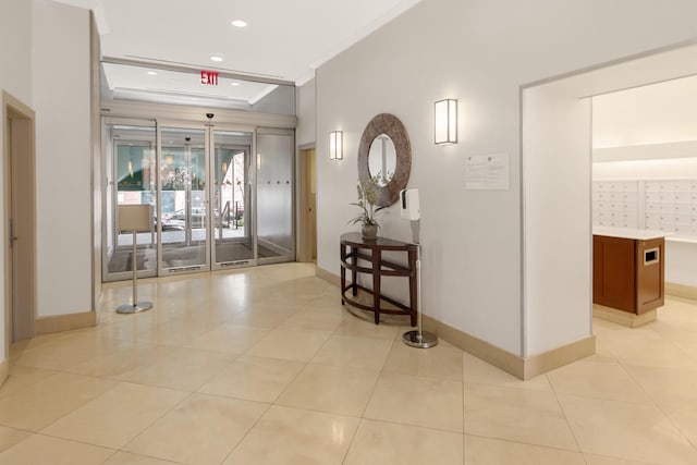 345 E 93rd St Unit 25Ak, New York Manhattan, NY 10128 - foyer with baseboards, a tray ceiling, crown molding, mail area, and light tile patterned flooring