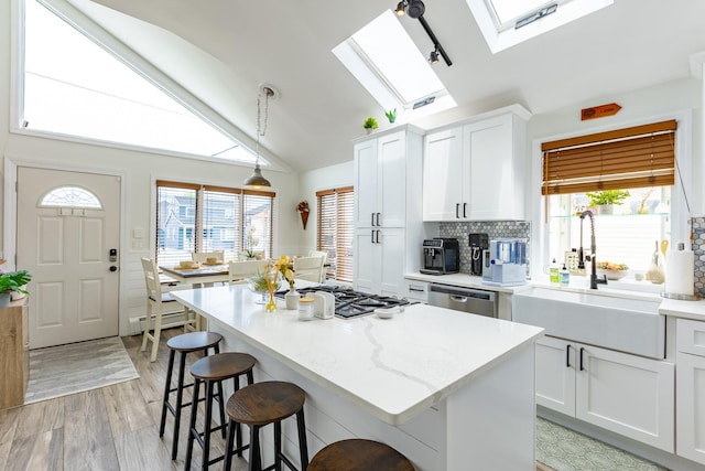 29 Mckinley Ave, Lindenhurst, NY 11757 - kitchen featuring a sink, a skylight, a breakfast bar area, healthy amount of natural light, and vaulted ceiling