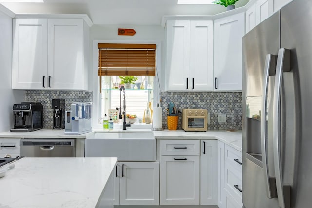 29 Mckinley Ave, Lindenhurst, NY 11757 - kitchen with appliances with stainless steel finishes, a sink, white cabinetry, and backsplash