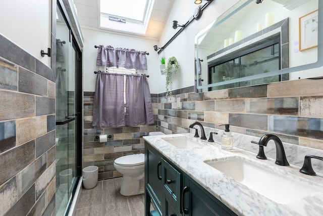 29 Mckinley Ave, Lindenhurst, NY 11757 - full bathroom with tile walls, toilet, a shower stall, double vanity, and a skylight