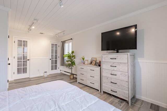 29 Mckinley Ave, Lindenhurst, NY 11757 - bedroom featuring rail lighting, access to outside, wainscoting, light wood-style flooring, and ornamental molding