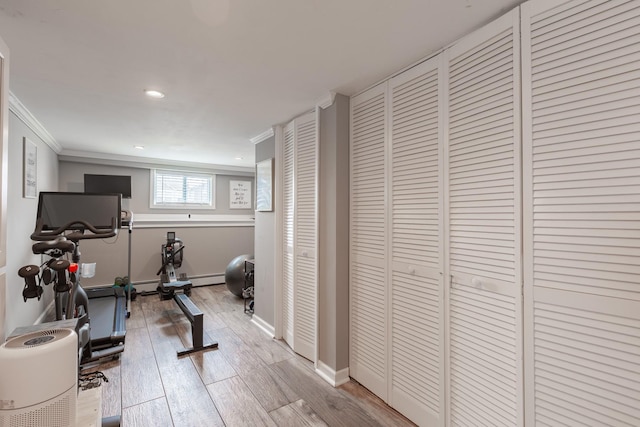 29 Mckinley Ave, Lindenhurst, NY 11757 - workout room with light wood-type flooring, ornamental molding, baseboard heating, recessed lighting, and baseboards