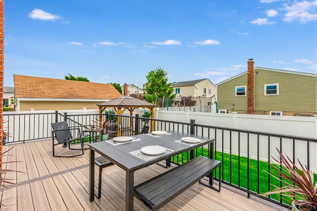 29 Mckinley Ave, Lindenhurst, NY 11757 - wooden deck with a gazebo, outdoor dining area, a fenced backyard, and a residential view