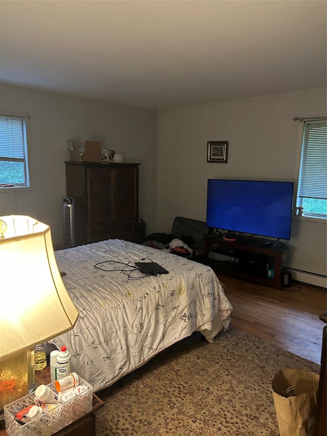 400 Old Rte 304, New City, NY 10956 - bedroom featuring a baseboard heating unit, multiple windows, and wood finished floors