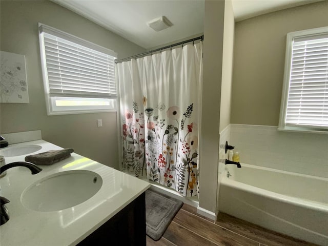 1234 State Route 17k, Montgomery, NY 12549 - full bathroom with wood finished floors, a bath, plenty of natural light, and double vanity