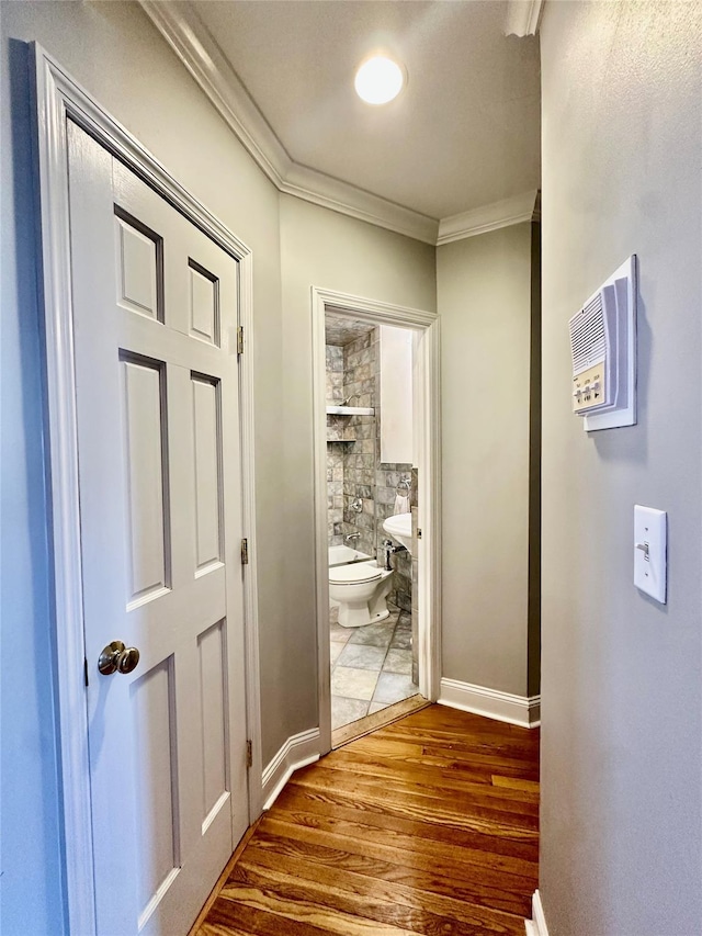 315 King St Unit 6H, Port Chester, NY 10573 - corridor featuring dark wood-style flooring, ornamental molding, and baseboards