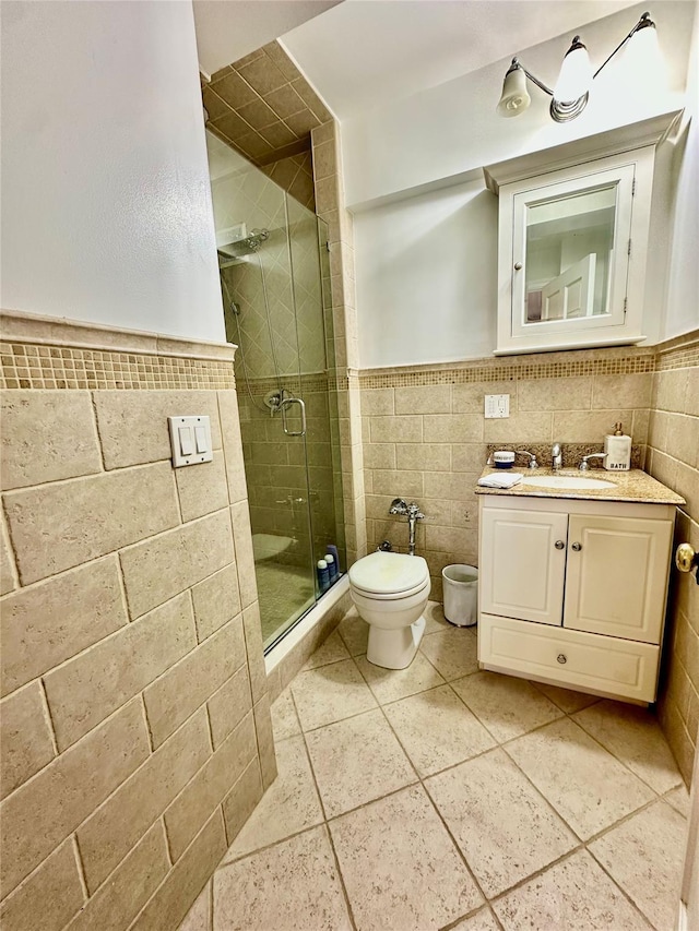 315 King St Unit 6H, Port Chester, NY 10573 - full bath with tile walls, vanity, tile patterned flooring, a stall shower, and a wainscoted wall