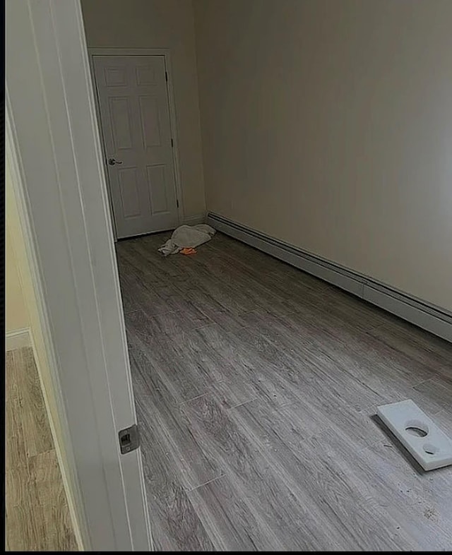 3215 Fairmount Ave, Bronx, NY 10465 - empty room with wood finished floors and baseboard heating