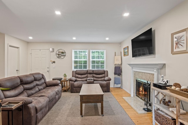 12 Franklin Commons, Yaphank, NY 11980 - living area featuring light wood-style floors, a fireplace with flush hearth, and recessed lighting