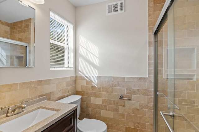 12 Franklin Commons, Yaphank, NY 11980 - bathroom featuring tile walls, a shower stall, vanity, toilet, and wainscoting