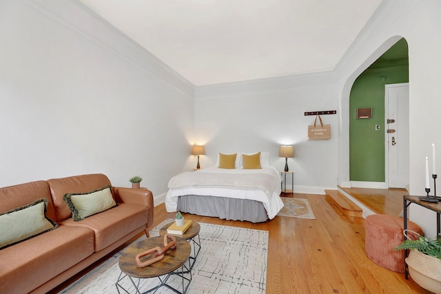 50 Lefferts Ave Unit 6M, Brooklyn, NY 11225 - bedroom with arched walkways, baseboards, and wood finished floors