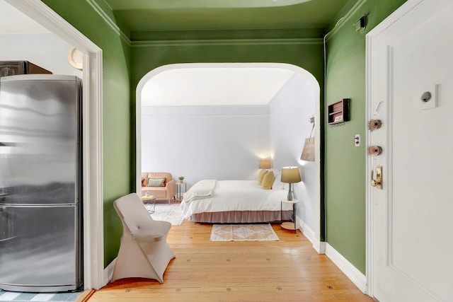50 Lefferts Ave Unit 6M, Brooklyn, NY 11225 - bedroom with freestanding refrigerator, arched walkways, and wood finished floors