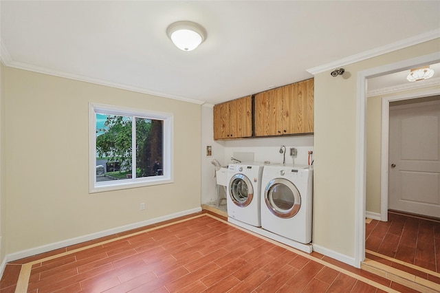 4 Mason Ct, Levittown, NY 11756 - laundry area featuring cabinet space, washing machine and clothes dryer, light wood-type flooring, baseboards, and crown molding
