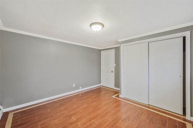 4 Mason Ct, Levittown, NY 11756 - unfurnished bedroom with ornamental molding, a closet, wood finished floors, baseboards, and a baseboard radiator