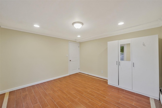 4 Mason Ct, Levittown, NY 11756 - below grade area with light wood-style floors, baseboards, ornamental molding, and recessed lighting