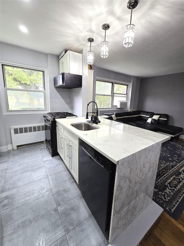 89-25 Shore Pkwy Unit 1L, Howard Beach, NY 11414 - kitchen featuring radiator heating unit, black appliances, a sink, light stone countertops, and white cabinetry
