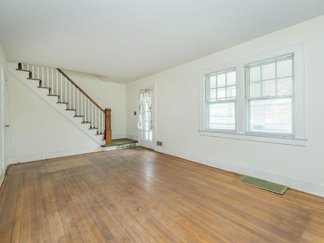 3 3rd St, Glenwood Landing, NY 11547 - unfurnished living room featuring stairs, wood finished floors, and baseboards