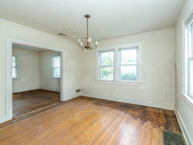 3 3rd St, Glenwood Landing, NY 11547 - spare room with a chandelier, light wood-style floors, plenty of natural light, and baseboards