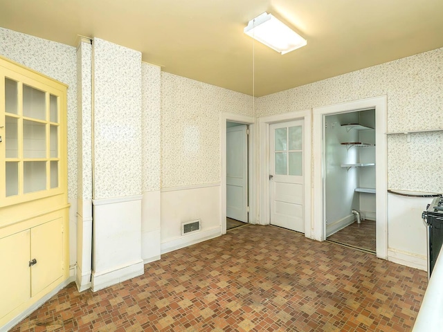 3 3rd St, Glenwood Landing, NY 11547 - spare room featuring wallpapered walls and a wainscoted wall