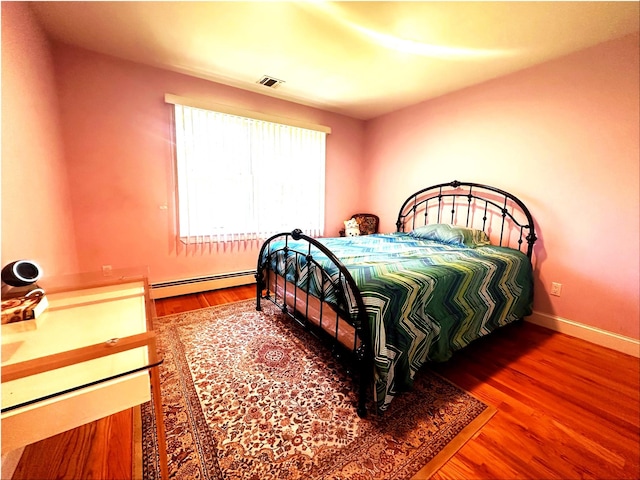 344 Ingrassia Rd, Middletown, NY 10940 - bedroom with wood finished floors, a baseboard heating unit, and baseboards