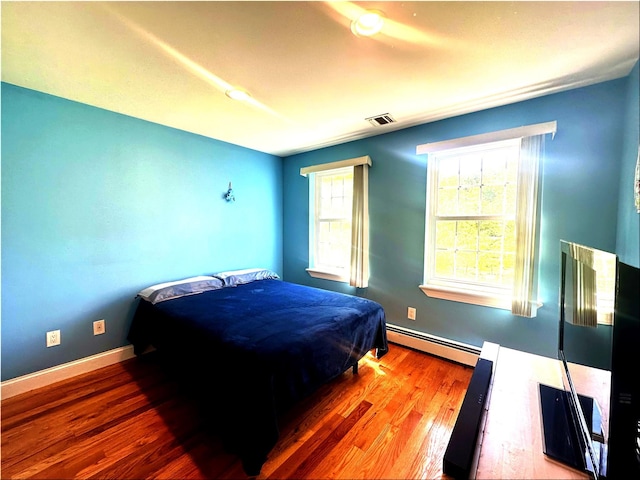 344 Ingrassia Rd, Middletown, NY 10940 - bedroom with baseboard heating, wood finished floors, and baseboards