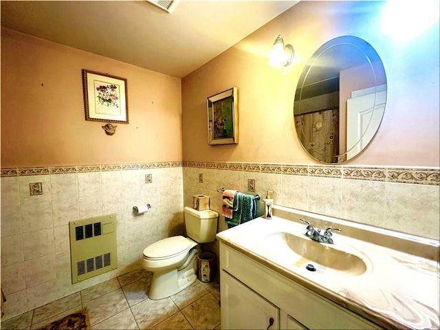 344 Ingrassia Rd, Middletown, NY 10940 - bathroom featuring vanity, tile walls, toilet, a wainscoted wall, and tile patterned floors