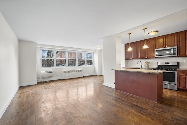 880 Boynton Ave Unit 1K, Bronx, NY 10473 - kitchen featuring appliances with stainless steel finishes, radiator, light stone counters, and dark wood-type flooring