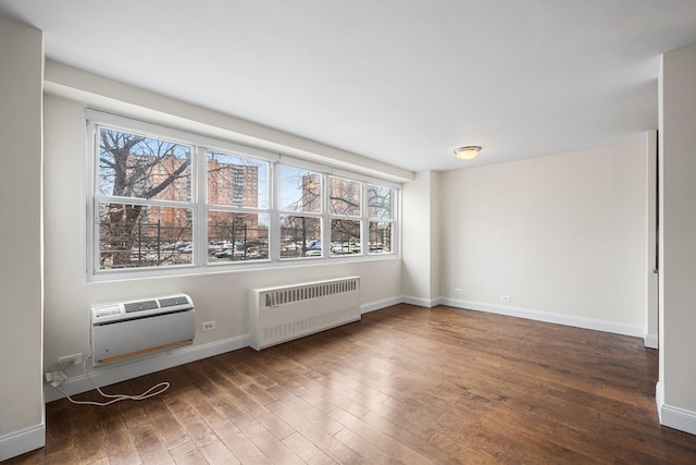 880 Boynton Ave Unit 1K, Bronx, NY 10473 - spare room featuring radiator heating unit, wood finished floors, plenty of natural light, and a wall mounted AC