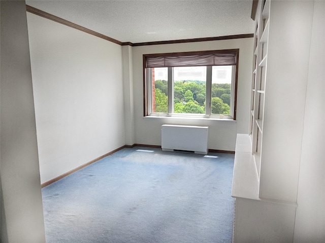 16 Rockledge Ave Unit 5B1, Ossining, NY 10562 - carpeted empty room with radiator heating unit, ornamental molding, baseboards, and a textured ceiling
