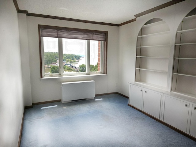 16 Rockledge Ave Unit 5B1, Ossining, NY 10562 - empty room with radiator heating unit, baseboards, ornamental molding, light carpet, and built in features