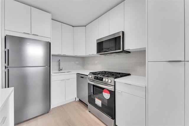 5700 Arlington Ave Unit 20K, Bronx, NY 10471 - kitchen with appliances with stainless steel finishes, a sink, light countertops, and light wood finished floors
