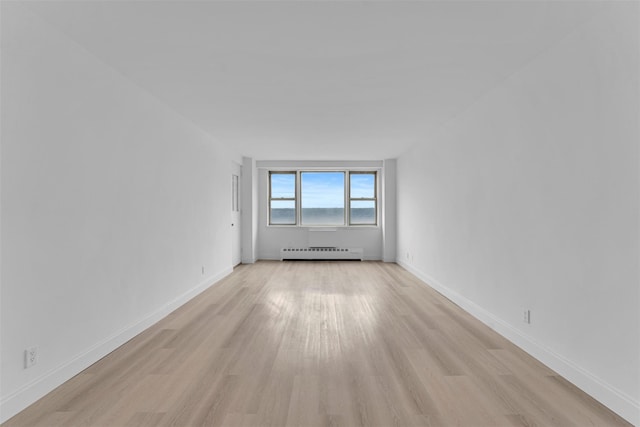 5700 Arlington Ave Unit 20K, Bronx, NY 10471 - empty room featuring baseboard heating, light wood finished floors, and baseboards