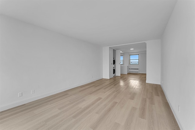 5700 Arlington Ave Unit 20K, Bronx, NY 10471 - unfurnished living room featuring radiator heating unit, light wood-style floors, and baseboards
