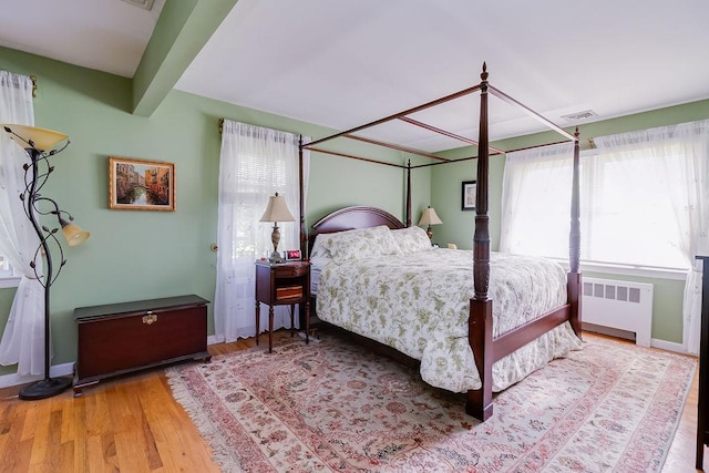 21 Maple Rd, Setauket, NY 11733 - bedroom featuring radiator, wood finished floors, and baseboards