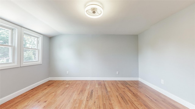 596 Terrace Pl, Baldwin, NY 11510 - spare room featuring light wood finished floors, baseboards, and lofted ceiling