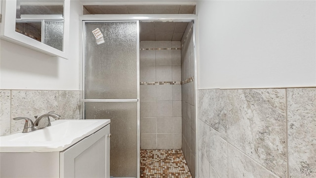 596 Terrace Pl, Baldwin, NY 11510 - full bath with tile walls, a stall shower, vanity, and a wainscoted wall
