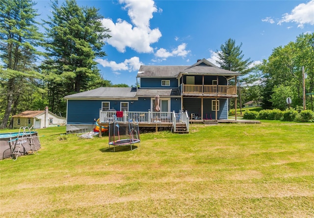 750 Irish Cape Rd, Ellenville, NY 12428 - back of house featuring a trampoline, a deck, and a yard