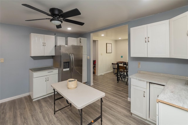 750 Irish Cape Rd, Ellenville, NY 12428 - kitchen with stainless steel fridge, white cabinets, baseboards, recessed lighting, and wood finished floors